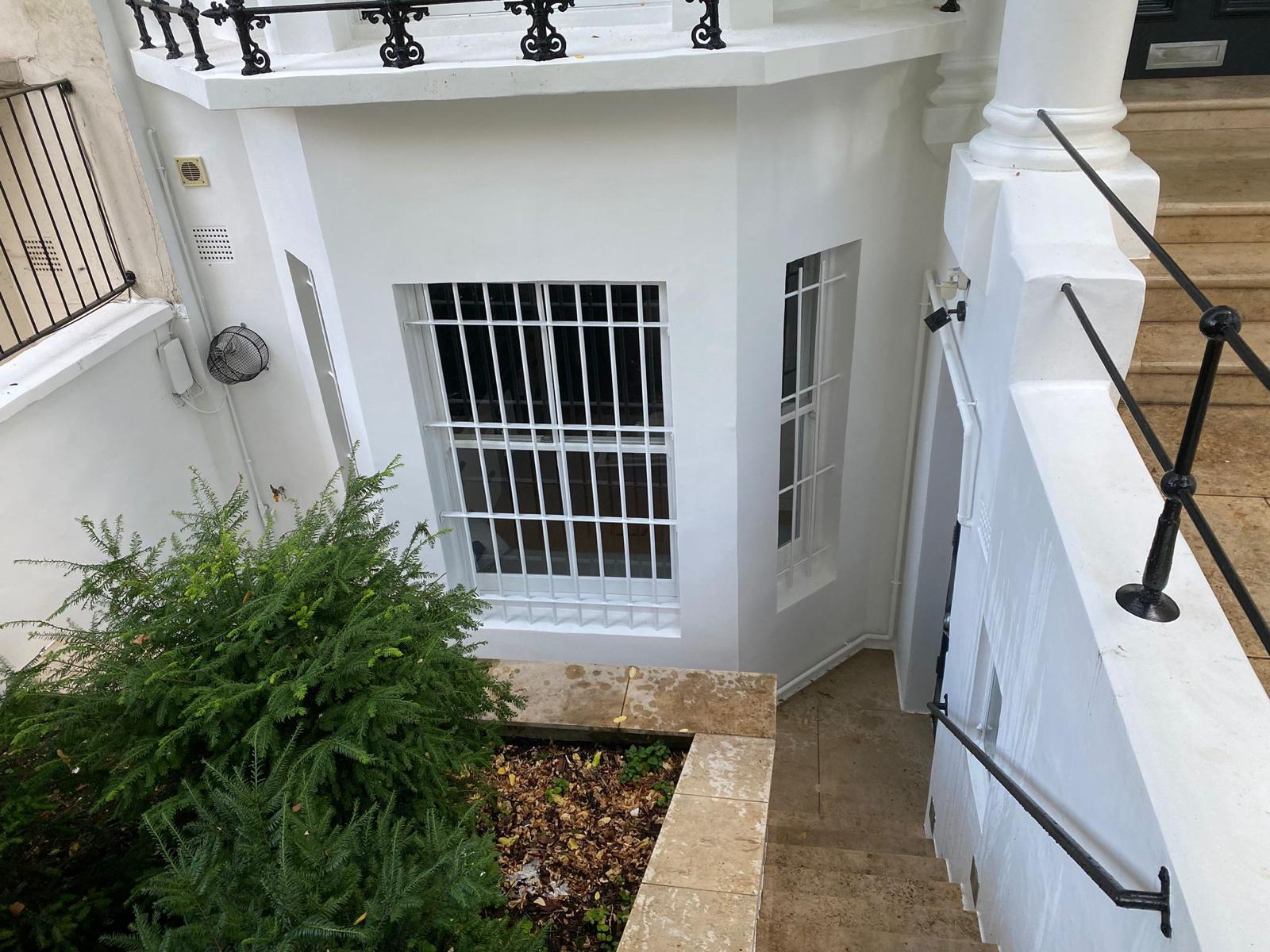 Lower ground entrance detailing and lightwell finish on a London townhouse